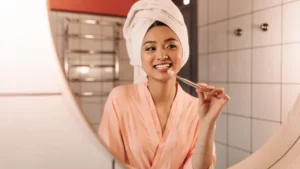 054261600_1748950313-brown-eyed-woman-white-towel-is-brushing-her-teeth